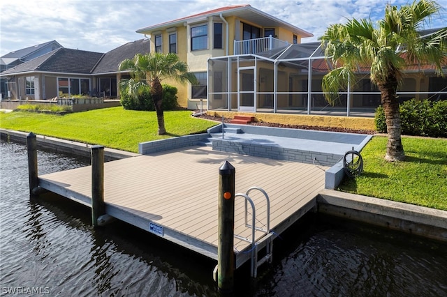 dock area featuring a water view, a lanai, and a lawn