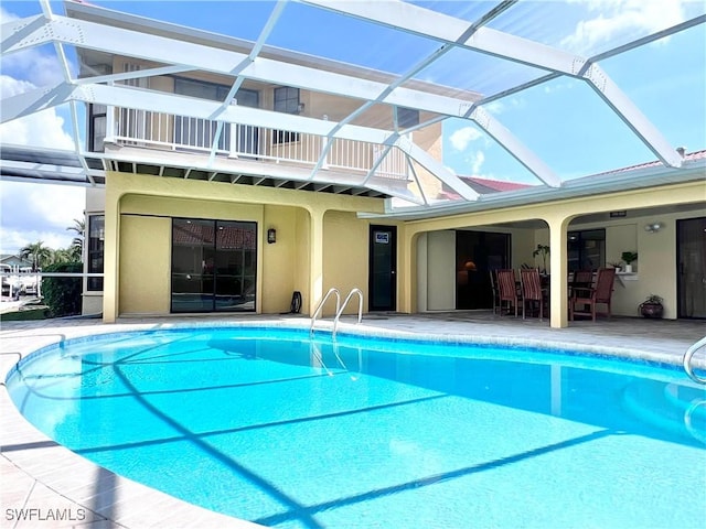 view of pool with a lanai and a patio area