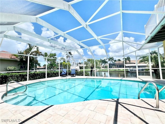 view of pool featuring a water view, glass enclosure, and a patio area