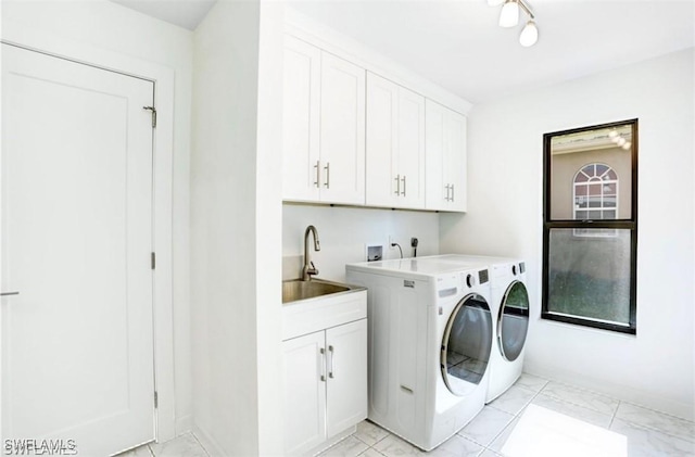 washroom featuring cabinets, independent washer and dryer, and sink