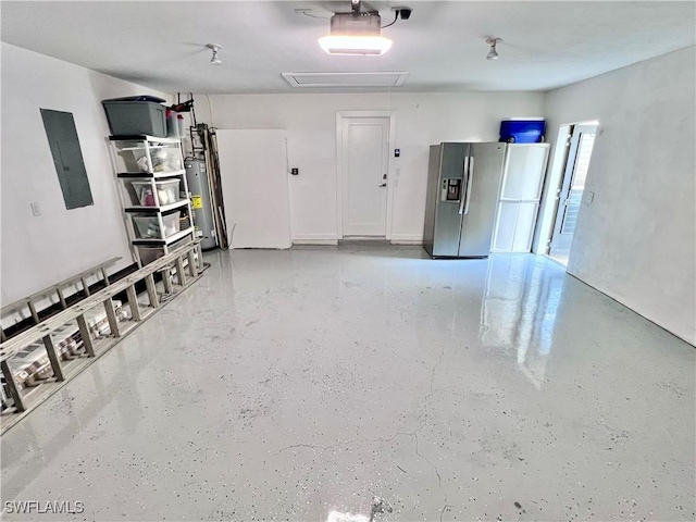 garage featuring water heater, stainless steel fridge, and electric panel