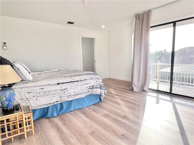 bedroom featuring hardwood / wood-style floors and access to outside