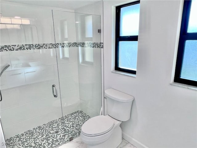 bathroom with an enclosed shower and toilet