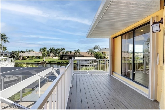 wooden terrace featuring a water view and a lanai