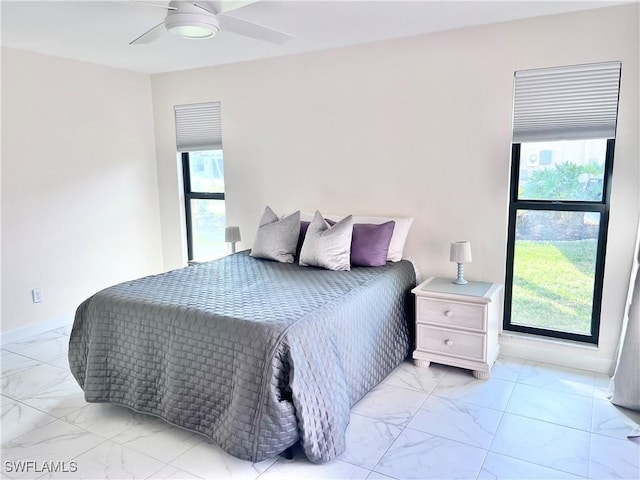 bedroom with multiple windows and ceiling fan