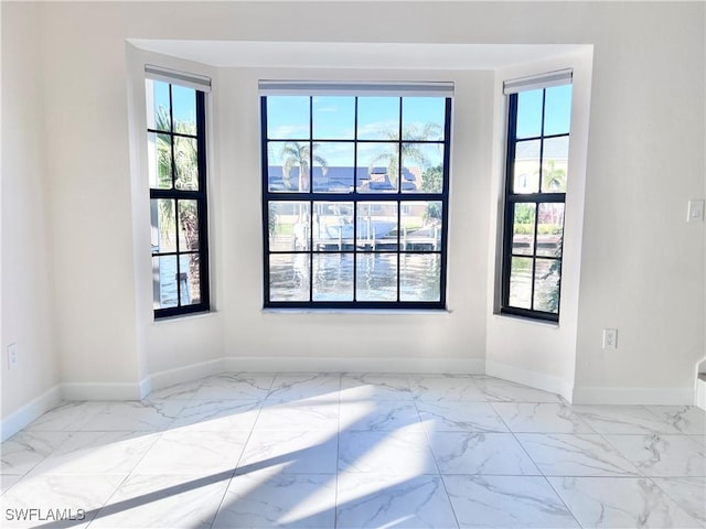 unfurnished room featuring a healthy amount of sunlight