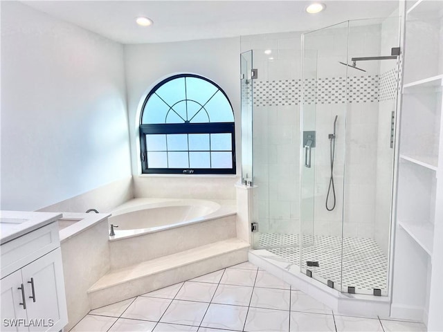 bathroom featuring vanity, tile patterned floors, and shower with separate bathtub