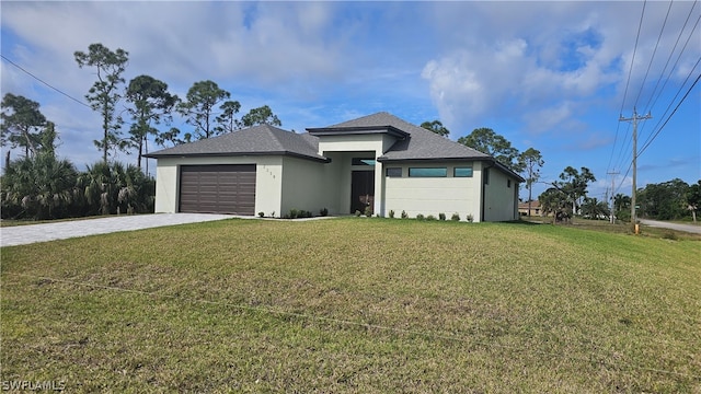 view of front of home featuring a garage and a front yard