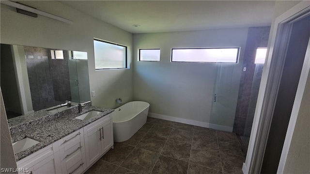 bathroom with a bathing tub, tile patterned flooring, and dual bowl vanity