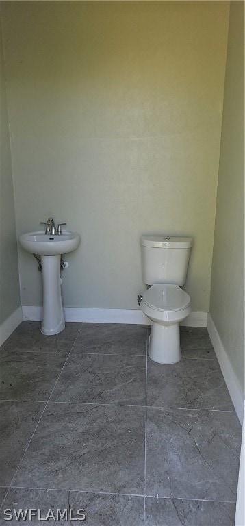 bathroom featuring toilet and tile patterned floors