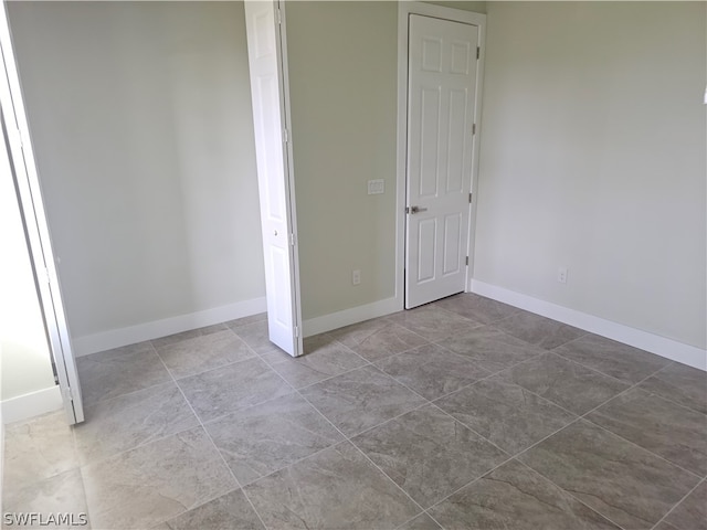 unfurnished bedroom featuring tile patterned flooring