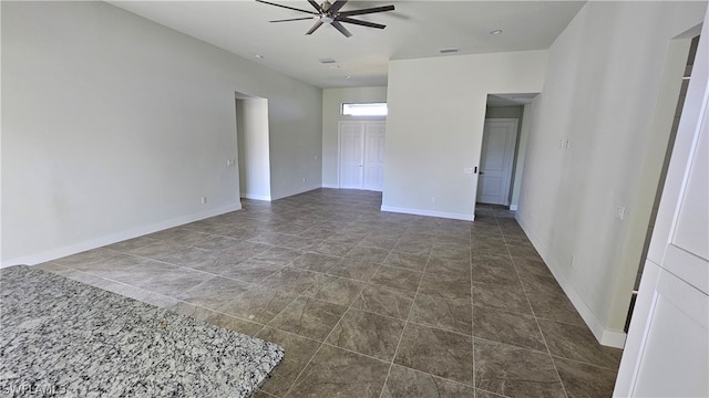 tiled empty room with ceiling fan