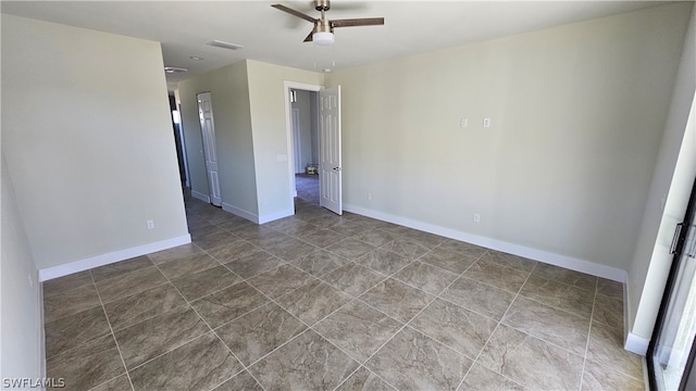 spare room with tile patterned floors and ceiling fan