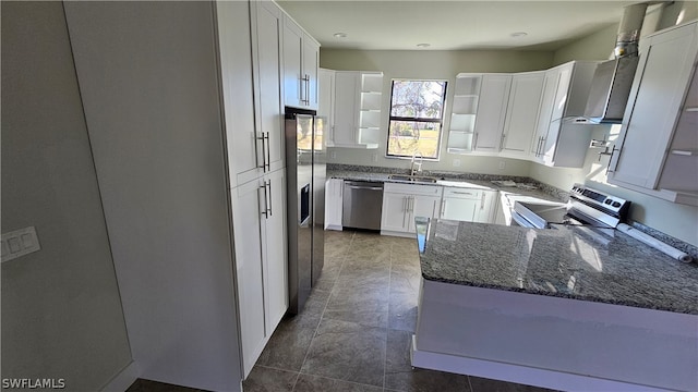 kitchen featuring dark stone counters, white cabinets, sink, appliances with stainless steel finishes, and dark tile patterned flooring