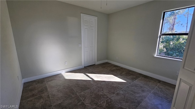 tiled empty room with a healthy amount of sunlight