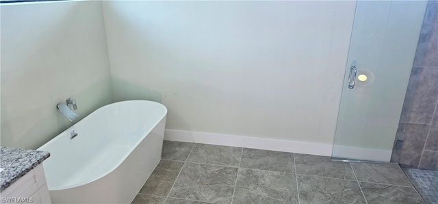 bathroom with vanity, tile patterned flooring, and a bath