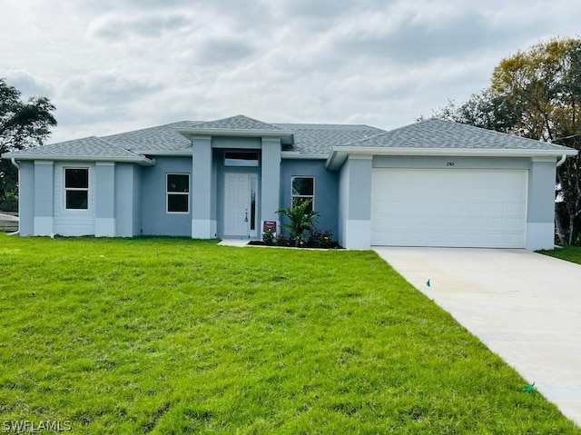 view of front of property with a garage and a front yard