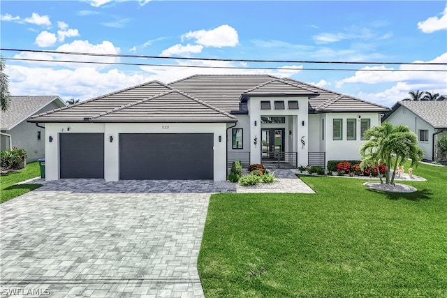 view of front of property featuring a garage and a front lawn