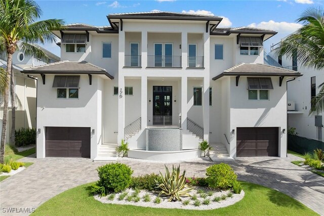 view of front of property with a balcony and a garage