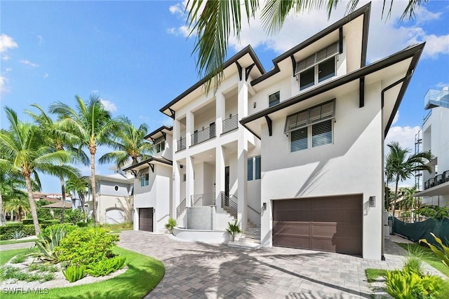 view of front of house with a balcony and a garage