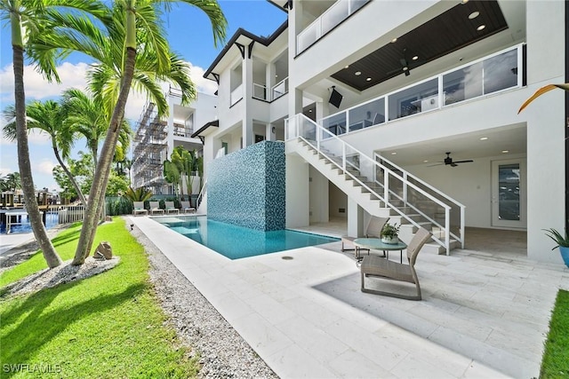 view of pool featuring ceiling fan and a patio area