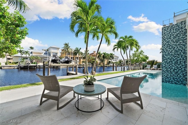 view of pool with a water view, a dock, and a patio area