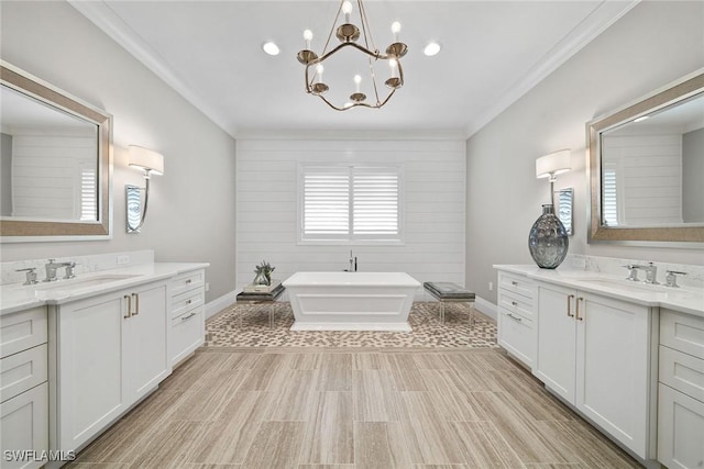 bathroom featuring vanity, a bathing tub, crown molding, hardwood / wood-style flooring, and a chandelier