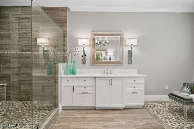 175 Conners Ave, Naples, FL 34108 - bathroom with vanity, a stall shower, baseboards, and a chandelier