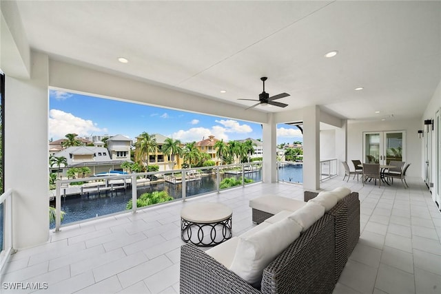 view of patio featuring outdoor lounge area, a water view, and ceiling fan