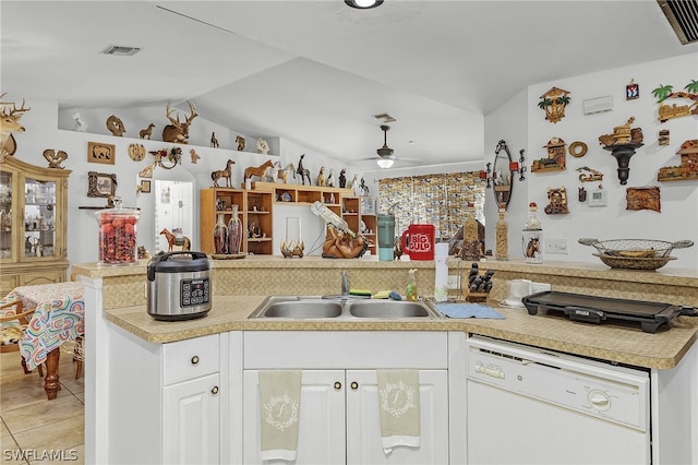 kitchen featuring white cabinets, vaulted ceiling, sink, dishwasher, and ceiling fan