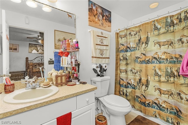 bathroom featuring vanity, tile patterned flooring, ceiling fan, and toilet