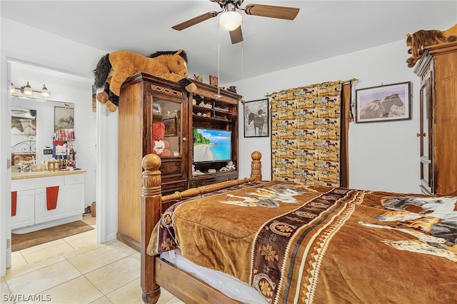 bedroom with light tile patterned flooring, ensuite bath, and ceiling fan