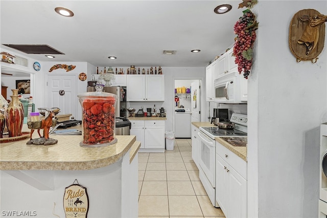 kitchen featuring washer / dryer, white cabinetry, white appliances, and light tile patterned floors