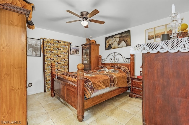 tiled bedroom featuring ceiling fan