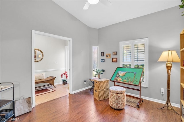 sitting room with ceiling fan and hardwood / wood-style flooring