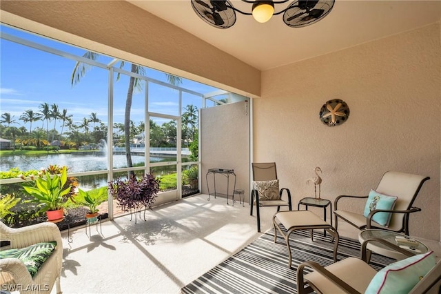 sunroom / solarium featuring a water view