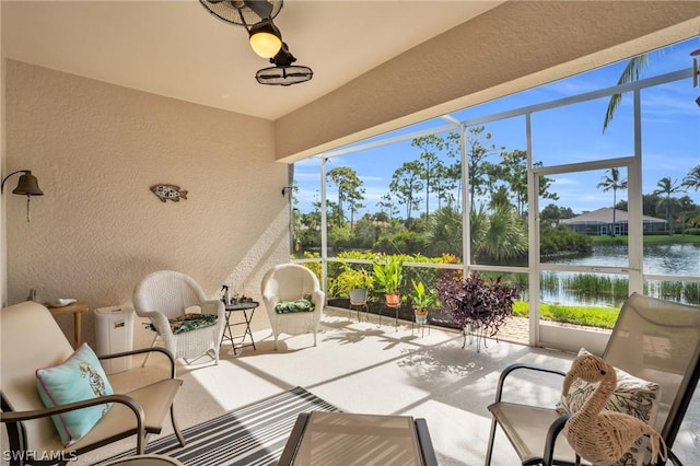 sunroom featuring a wealth of natural light and a water view