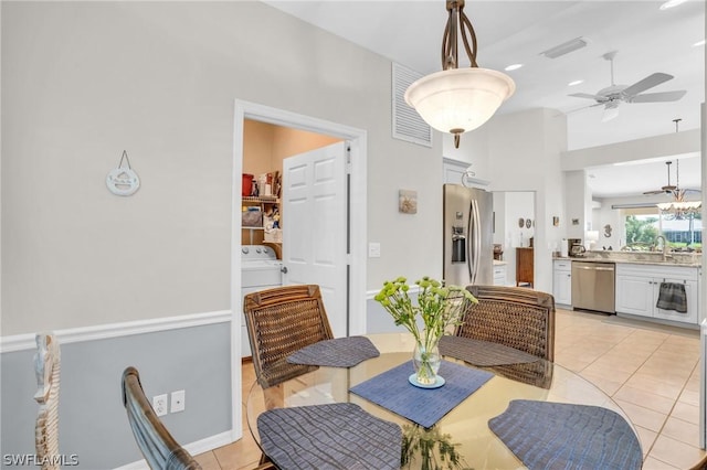 tiled dining area featuring ceiling fan and sink