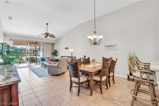 tiled dining room with vaulted ceiling and ceiling fan with notable chandelier