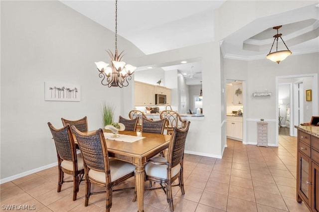 dining room with a raised ceiling, light tile patterned floors, an inviting chandelier, and crown molding