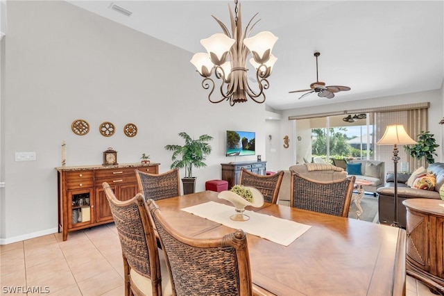 tiled dining space with ceiling fan with notable chandelier