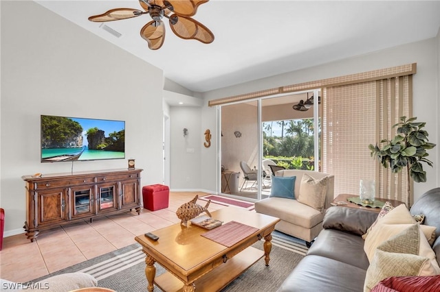 tiled living room featuring ceiling fan and vaulted ceiling