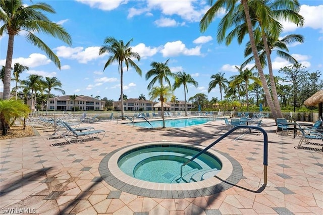 view of pool featuring a patio area and a hot tub