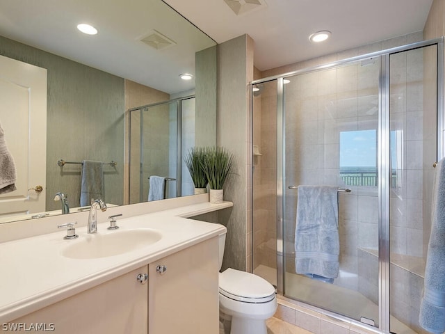 bathroom featuring vanity, an enclosed shower, toilet, and a water view