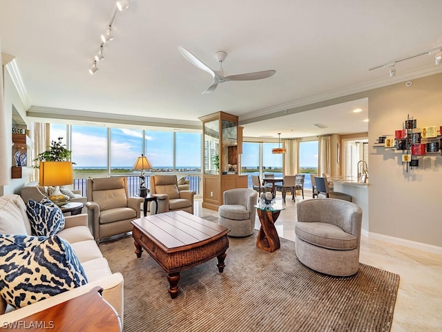 living room with crown molding, ceiling fan, rail lighting, and a water view