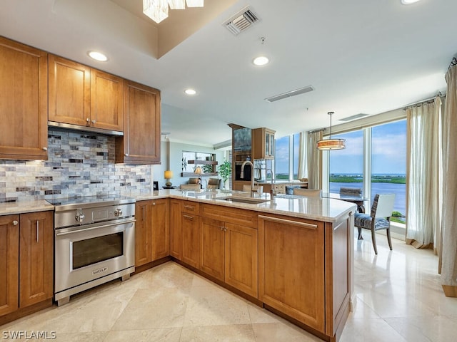 kitchen with high end stainless steel range, sink, a water view, ventilation hood, and kitchen peninsula