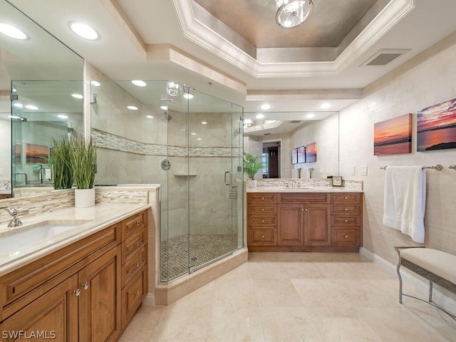 bathroom with vanity, a tray ceiling, and a shower with shower door