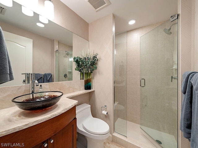 bathroom with vanity, walk in shower, and toilet