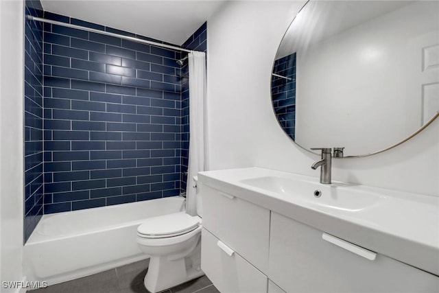 full bathroom featuring tile patterned flooring, vanity, toilet, and tiled shower / bath combo