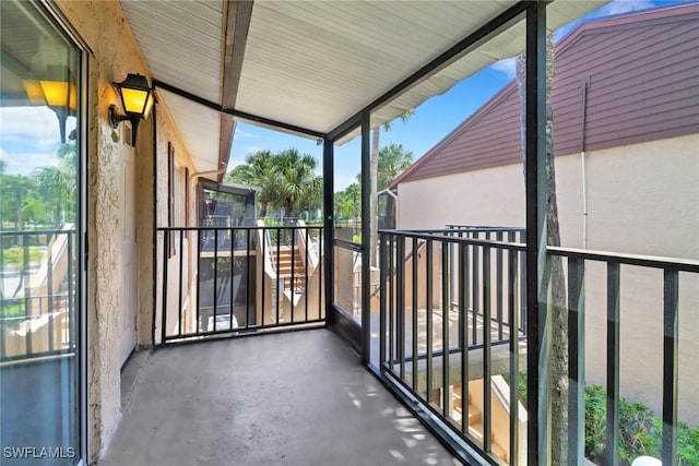 unfurnished sunroom featuring lofted ceiling